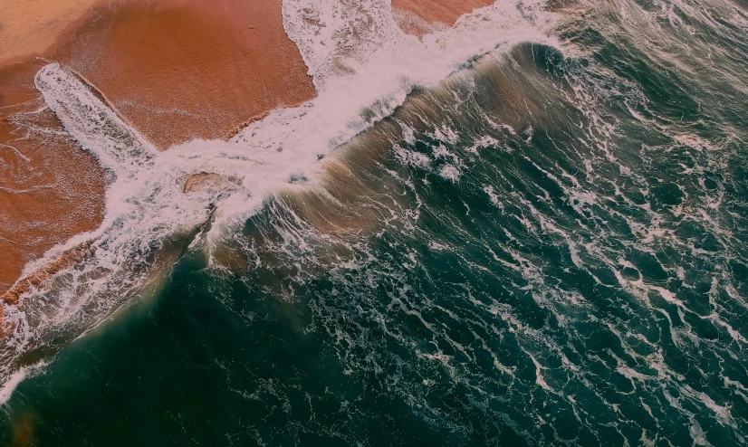 a large body of water next to a sandy beach, pexels contest winner, happening, mutiversal tsunami, 4 k hd wallpapear, high angle shot, charybdis