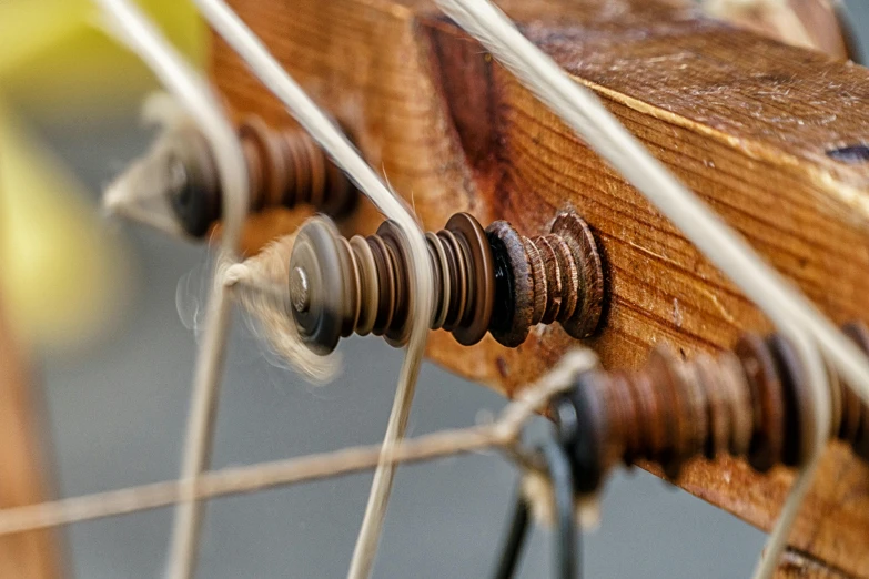 a close up of a close up of a wooden object, by David Simpson, unsplash, kinetic art, cords and wires, trireme, macuahuitl, slide show