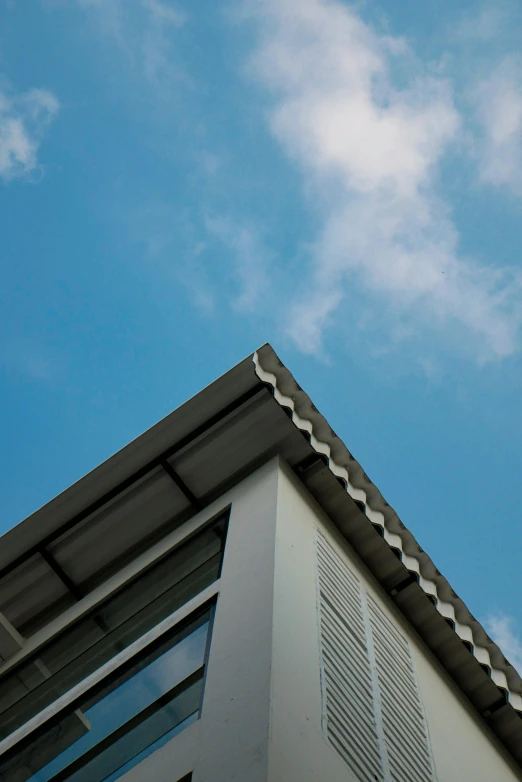 the top of a building with a blue sky in the background, profile image, architectural finishes, soft grey and blue natural light, shutters