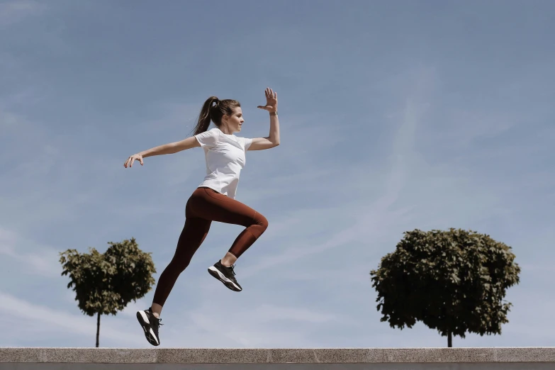 a woman flying through the air while riding a skateboard, pexels contest winner, arabesque, avatar image, dynamic active running pose, be running up that hill, on a pedestal