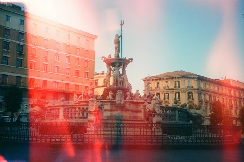 a fountain in the middle of a city with buildings in the background, pexels contest winner, neoclassicism, vibrant light leaks, square, roma, sunfaded