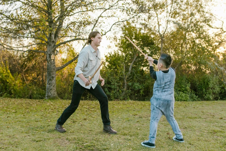 a woman and a child playing baseball in a field, unsplash, holding a sword and a chisel, avatar image, bo burnham, kung fu