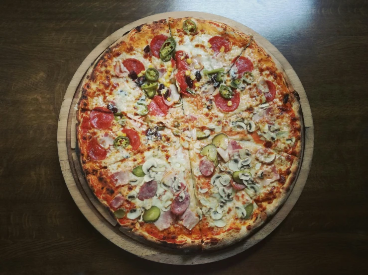 a pizza sitting on top of a wooden cutting board, by Carey Morris, pexels, multi - coloured, round faced, thumbnail, a high angle shot