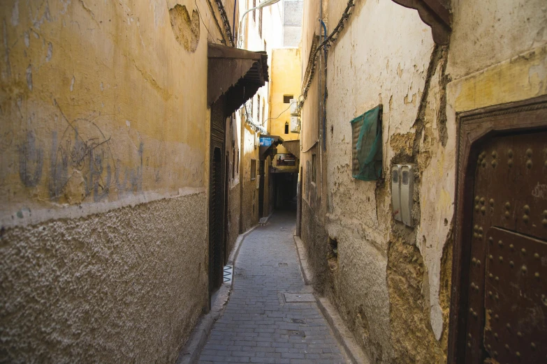 a narrow street in an old european city, by Riad Beyrouti, unsplash contest winner, les nabis, sand - colored walls, sparsely populated, an escape room in a small, a messy