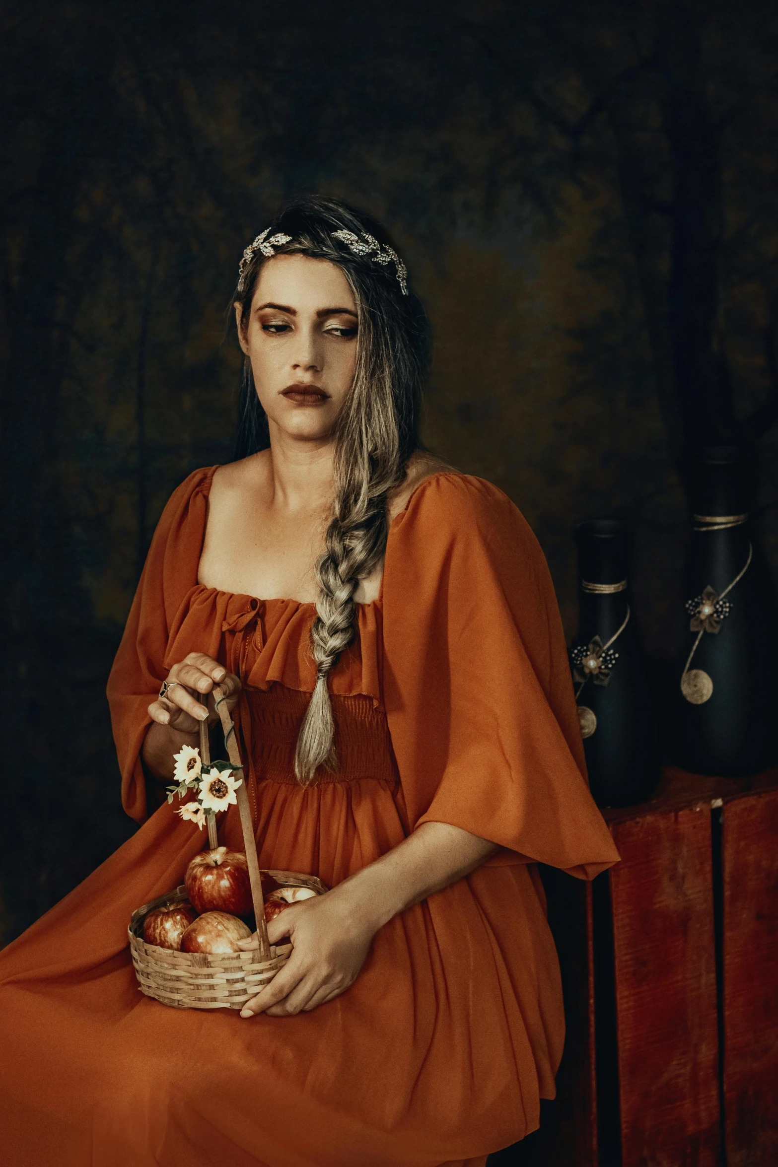 a woman in an orange dress sitting on a chair, an album cover, inspired by Artemisia Gentileschi, pexels contest winner, pre-raphaelitism, medieval dress. witch, alessio albi, promotional image, joel peter witkin