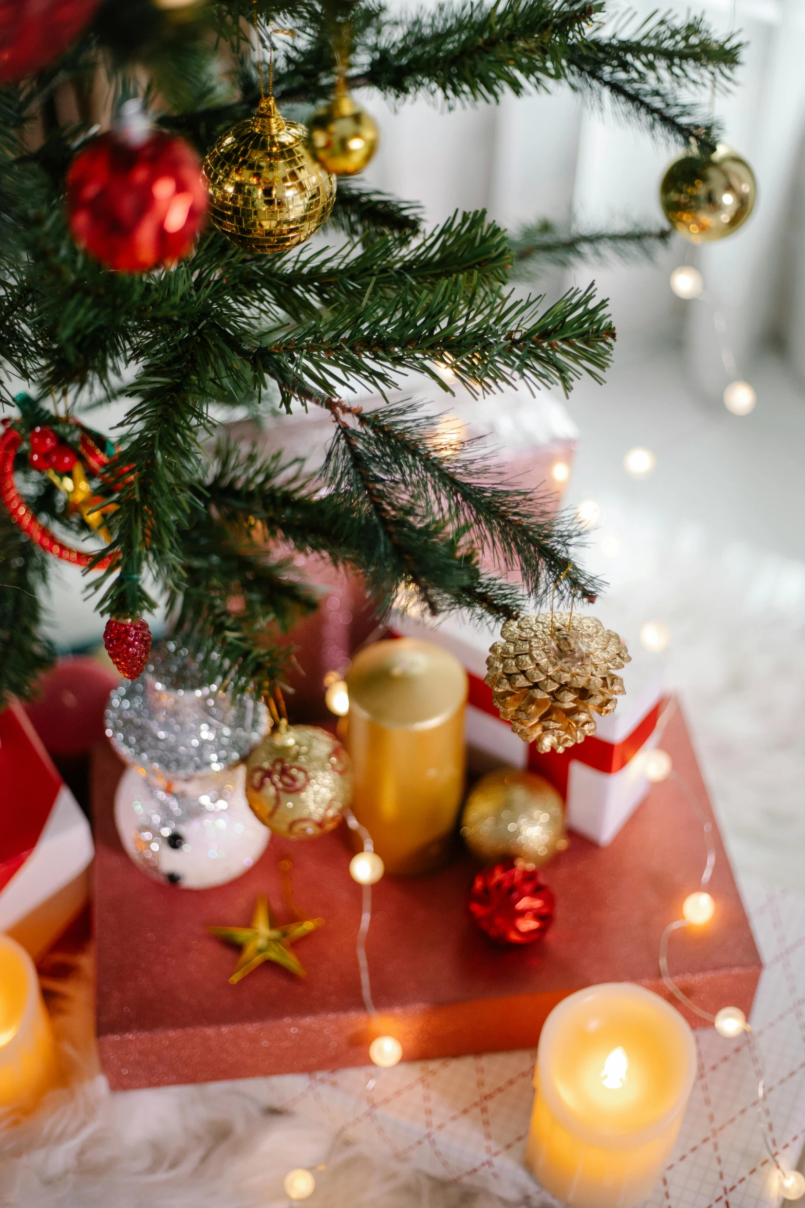 a christmas tree decorated with candles and ornaments, a cartoon, trending on pexels, high angle close up shot, gifts, square, sun shining