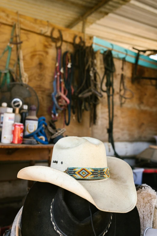 a cowboy hat sitting on top of a wooden table, inside a shed, elaborate hairstyles, slide show, no cropping
