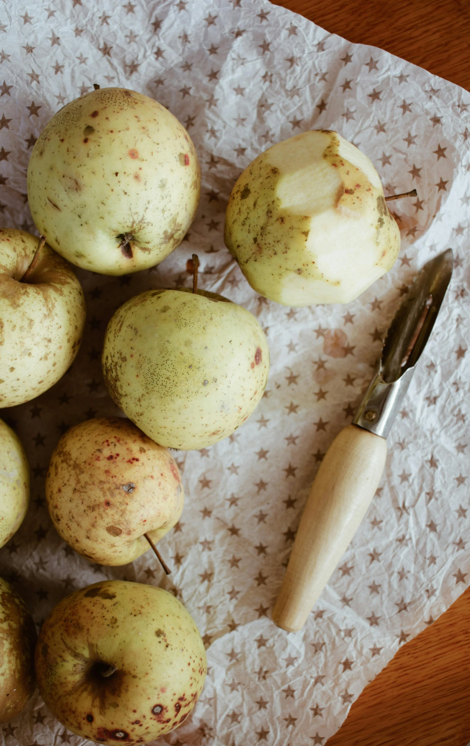 a bunch of apples sitting on top of a table, a still life, unsplash, mash potatoes, low quality photo, thumbnail, speckled