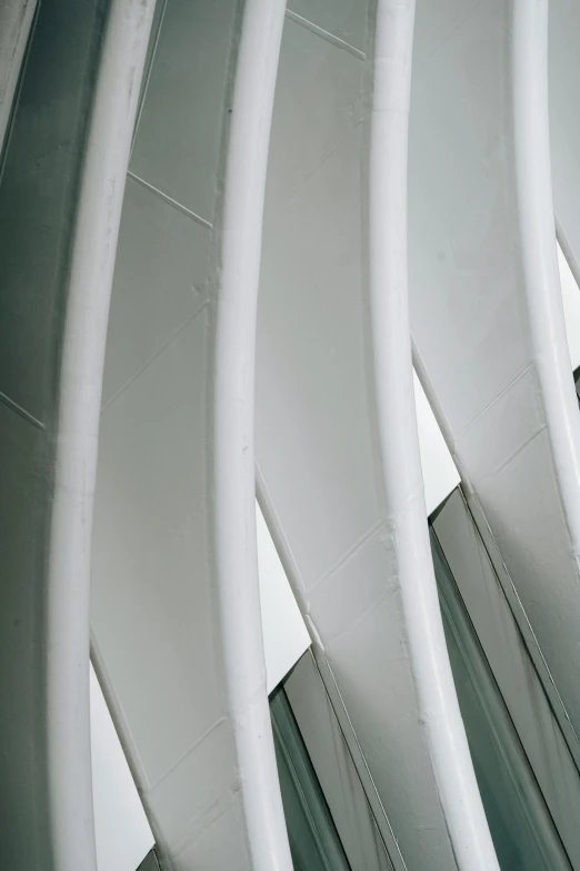 a clock mounted to the side of a building, inspired by Zaha Hadid, unsplash, light and space, white sweeping arches, detail structure, coated pleats, high ceiling