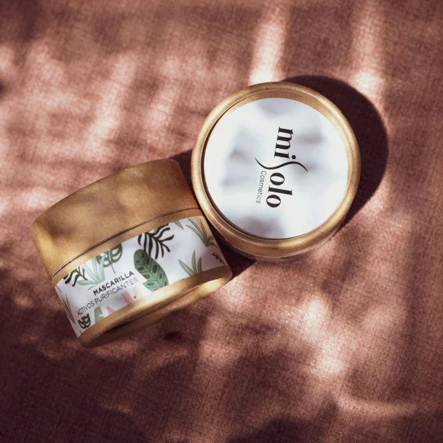 a jar of body butter sitting on top of a table, by Emma Andijewska, miko, gold colours, wild jungle, yotobi