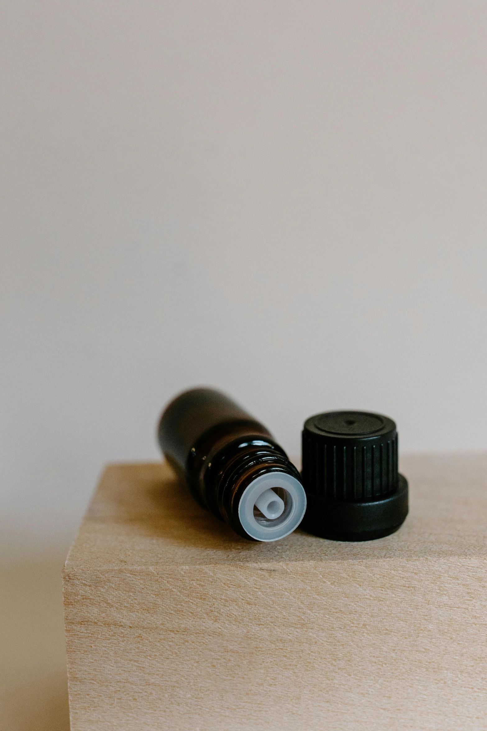 a couple of bottles sitting on top of a wooden block, product image, 1 4 mm, black fine lines on warm brown, smelling good