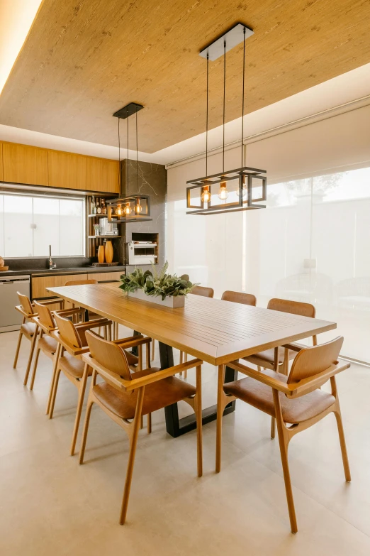 a dining room with a wooden table and chairs, by Felipe Seade, unsplash, light and space, kitchenette and conferenceroom, shaded lighting, colombian, luxury bespoke kitchen design