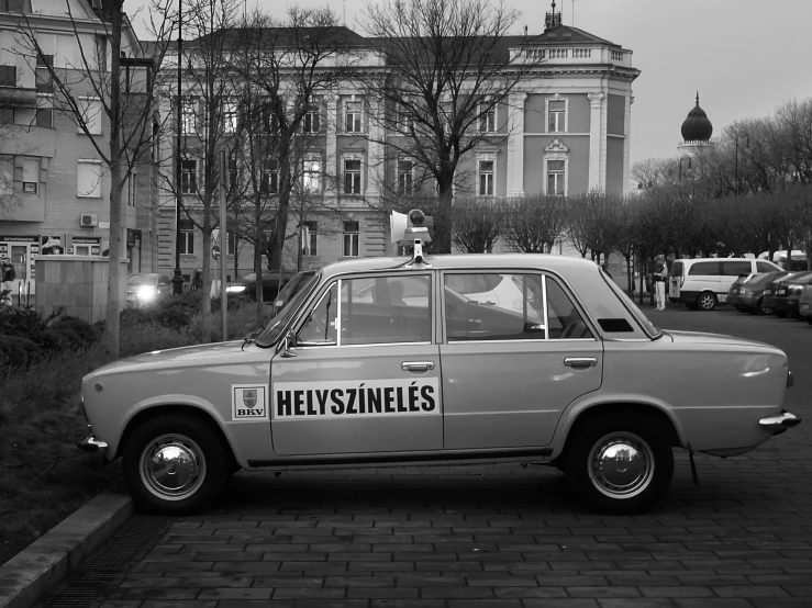 a black and white photo of a police car, a photo, by Henryk Rodakowski, hyperrealism, streets of heidelberg, 2 0 0 0's photo, taxi, advertising