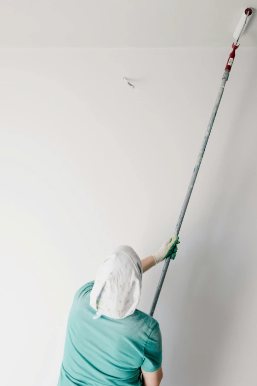 a person painting a wall with a paint roller, by Ben Zoeller, hyperrealism, tall ceiling, surgical supplies, photographed for reuters, sweeping