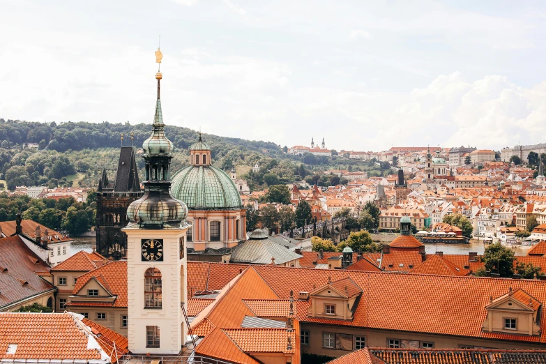 a view of a city from the top of a hill, by Emma Andijewska, pexels contest winner, baroque, orange roof, square, ivory and copper, youtube thumbnail