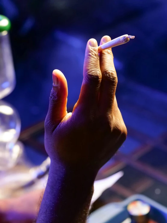 a person holding a cigarette in their hand, happening, at a bar, profile image, weed, thumbnail