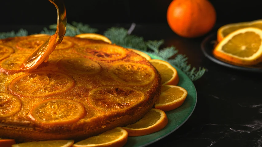 a cake sitting on top of a plate covered in orange slices, by Carey Morris, trending on pexels, renaissance, syrup, moroccan, stipple, holiday season