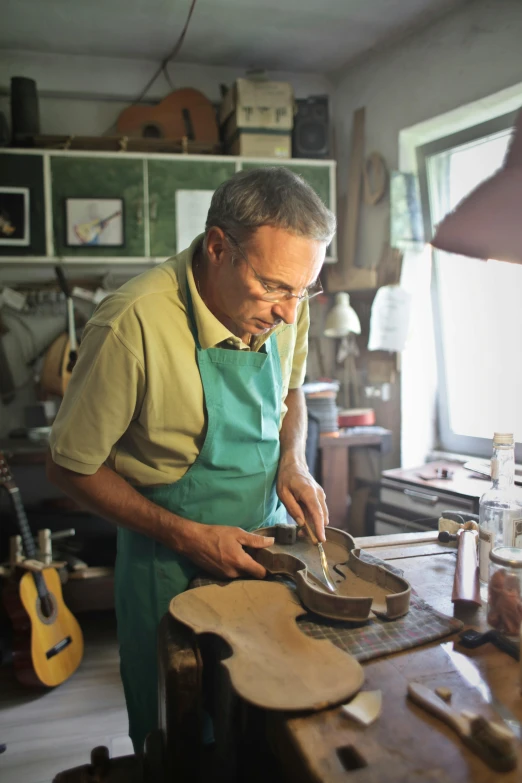 a man working on a guitar in a workshop, an album cover, violin, inspect in inventory image, profile picture, thumbnail