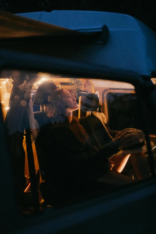 a couple of people that are sitting in a car, pexels contest winner, cinematic light and reflections, lit from behind, microbus, ignant