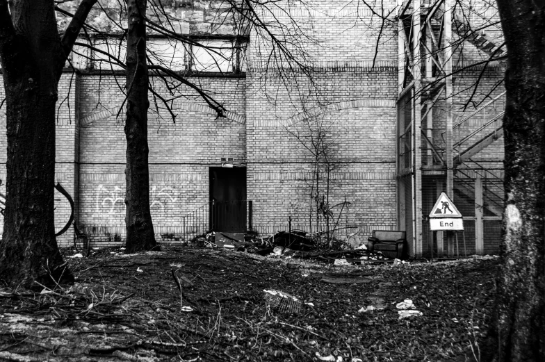 a black and white photo of a building in the woods, a photo, post apocalyptic street, post - soviet courtyard, shut down, outdoor photo