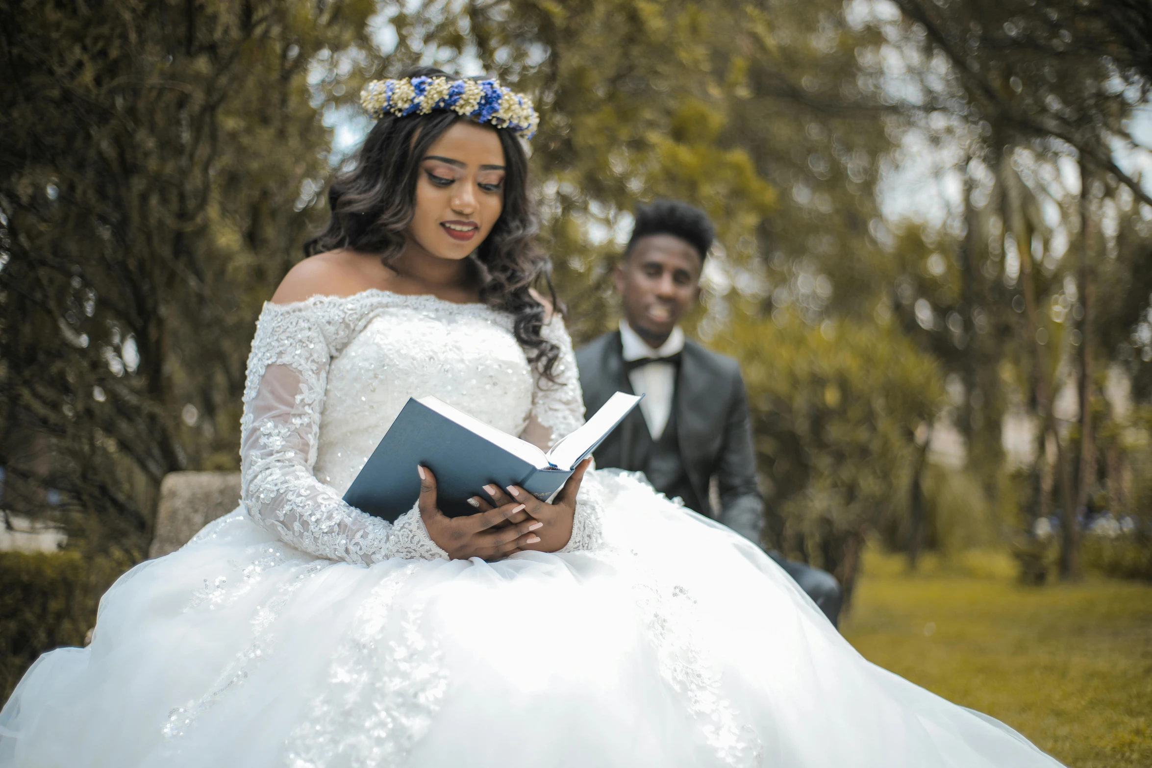 a man in a tuxedo sitting next to a woman in a wedding dress, a photo, by Chinwe Chukwuogo-Roy, pexels contest winner, holding a book, 15081959 21121991 01012000 4k, wearing a tiara, thumbnail