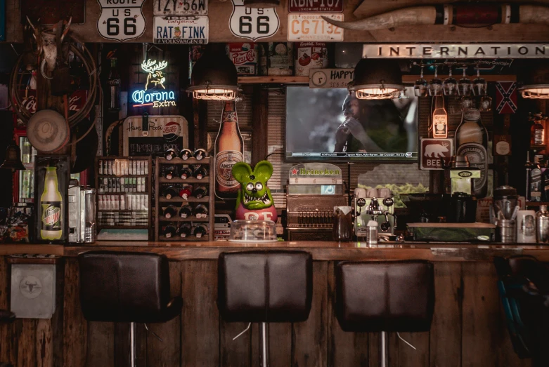 a couple of stools sitting in front of a bar, a portrait, unsplash, vintage photo, cowboy themed, dive bar with a karaoke machine, profile image