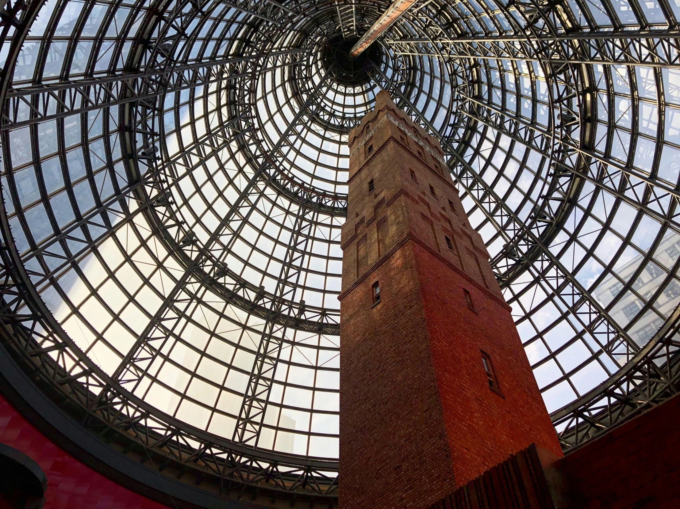 a tall clock tower sitting inside of a building, inspired by Sydney Prior Hall, interactive art, giant glass dome in space, in a massive cavernous iron city, skylights, melbourne