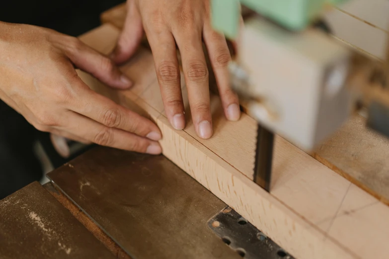 a person using a band saw to cut a piece of wood, trending on pexels, arts and crafts movement, indi creates, thumbnail, plating, rectangle