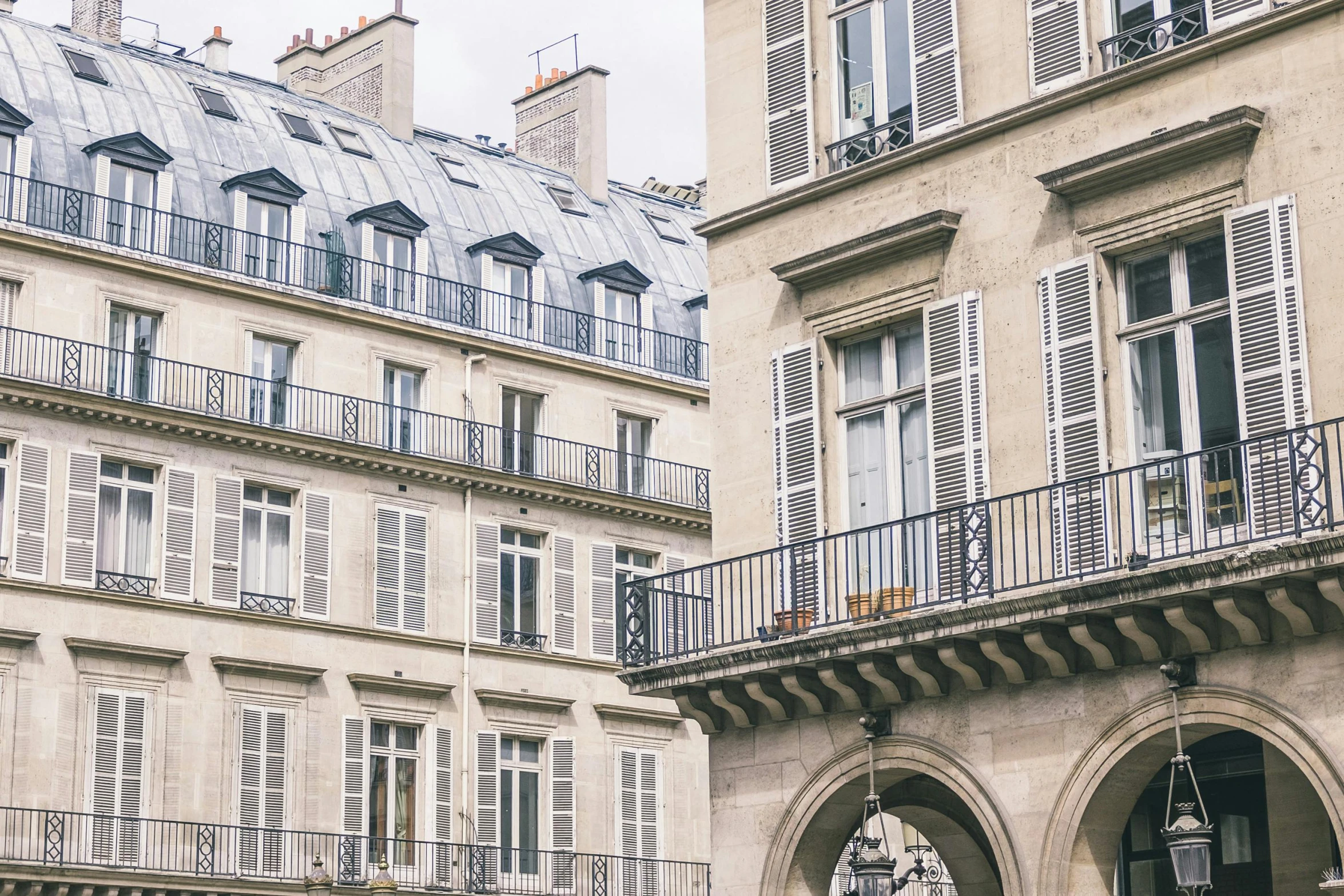 a group of people walking down a street next to tall buildings, pexels contest winner, paris school, blue shutters on windows, taupe, regency-era, balcony