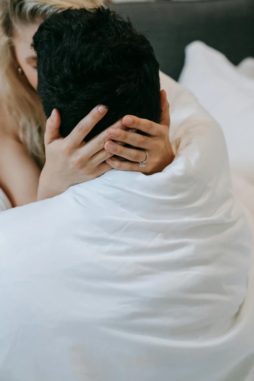 a man and a woman cuddling on a bed, unsplash, his arms are behind his back, detail shot, te pae, gif