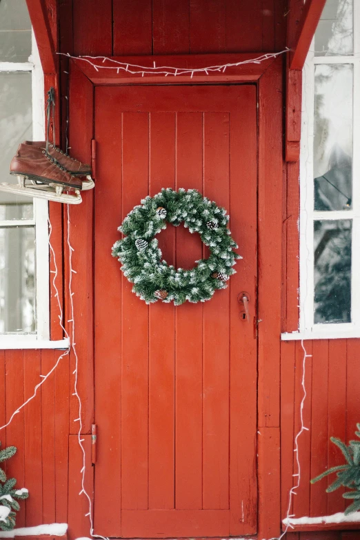 a red house with a wreath on the front door, by Julia Pishtar, pexels, light inside the hut, with white, lookbook, made of glazed