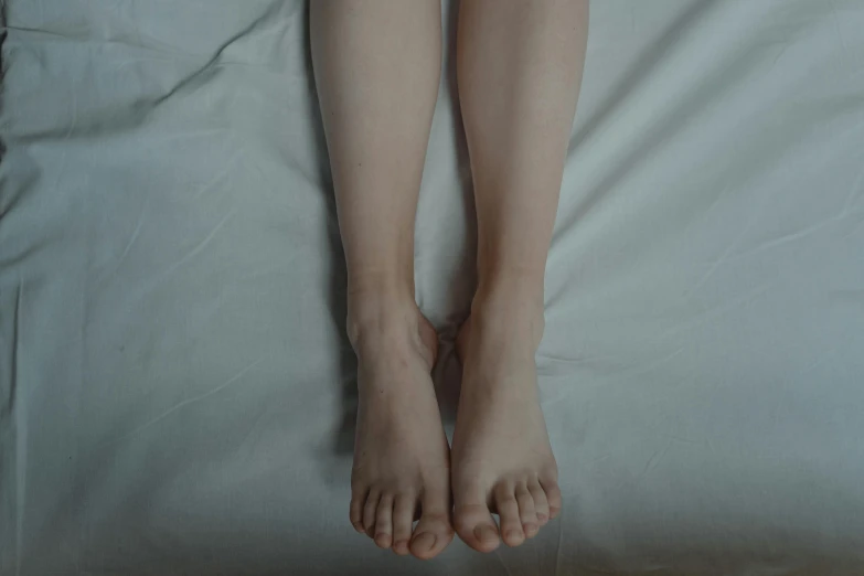a close up of a person's legs on a bed, pexels, hyperrealism, rinko kawauchi, full body picture, pale fair skin, highly symmetric body parts