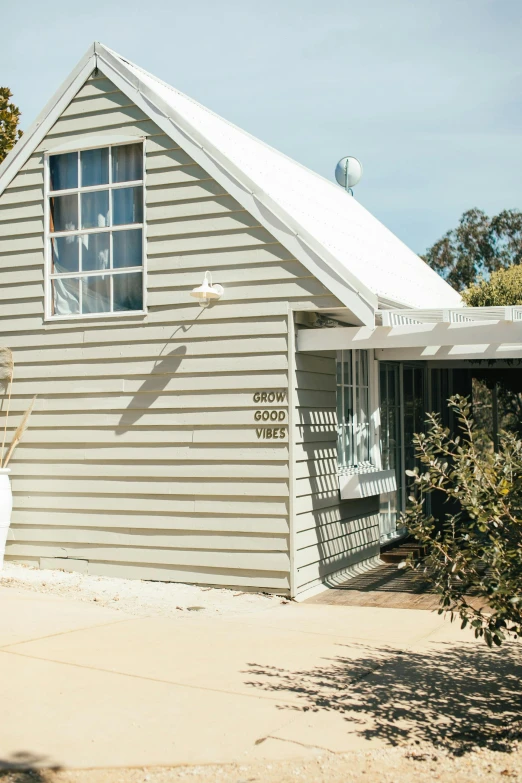 a house with a car parked in front of it, a picture, by Gwen Barnard, unsplash, pale greens and whites, eucalyptus, cottage close up, angle view