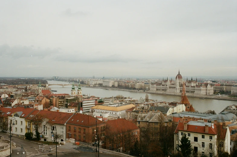 a view of a city from the top of a hill, a photo, pexels contest winner, danube school, slight overcast, 90s photo, slide show, emily rajtkowski