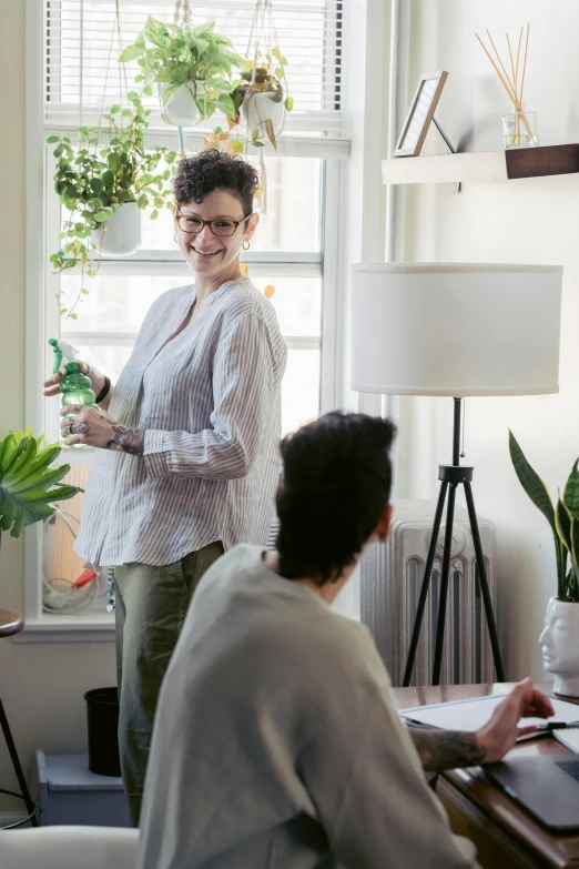 a woman giving a presentation to a group of people, pexels contest winner, renaissance, home office, next to a plant, rebecca sugar, ignant