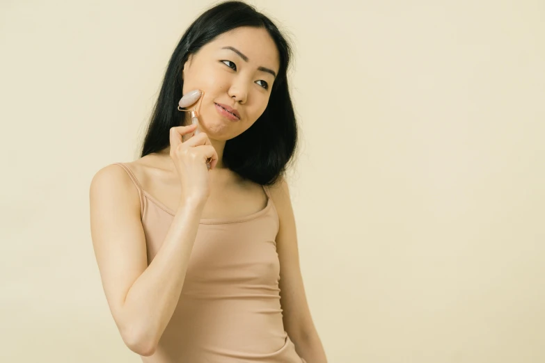 a woman brushing her teeth with a brush, a character portrait, inspired by Wen Jia, trending on pexels, mingei, round jawline, silicone skin, on a pale background, wearing translucent sheet