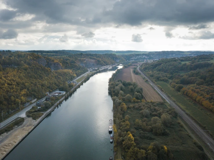 a large body of water next to a forest, by Werner Gutzeit, pexels contest winner, figuration libre, industrial surrounding, detmold, 4 k cinematic panoramic view, normandy