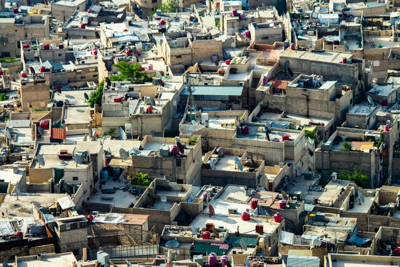 an aerial view of a city with lots of buildings, pexels contest winner, les nabis, kurdistan, hiding in the rooftops, coloured, beige