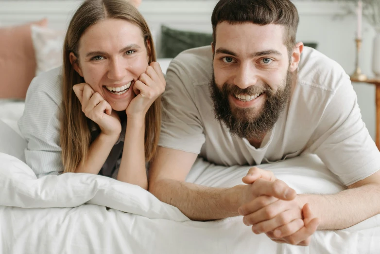 a man and a woman laying on a bed, pexels contest winner, welcoming grin, avatar image, thumbnail, high quality image