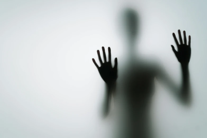 a silhouette of a person behind a frosted glass, pexels, surrealism, zombie arms out in front, gray alien, with a white background, floating ghost