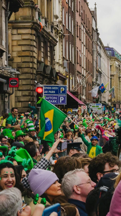 a group of people that are standing in the street, pexels contest winner, happening, brazilian flag, irish, 🚿🗝📝, room is full of people