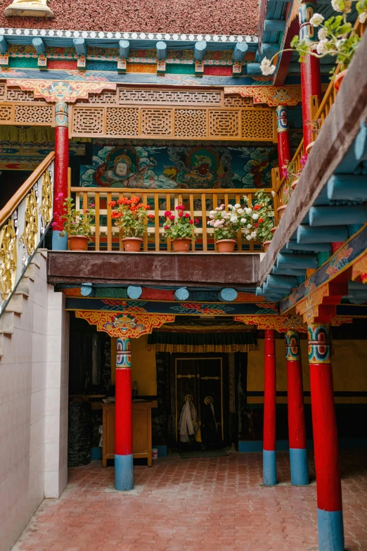 a red and blue staircase leading up to a building, a detailed painting, inspired by Zhang Shengwen, trending on unsplash, cloisonnism, nepal, gigantic pillars and flowers, wooden interior, square