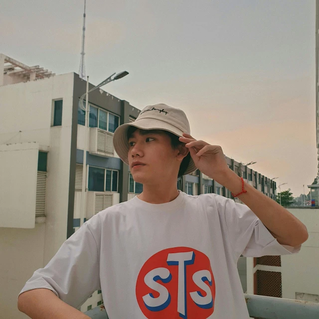 a man in a white shirt and a hat, tumblr, sots art, set on singaporean aesthetic, she is wearing streetwear, simple logo, artstatio