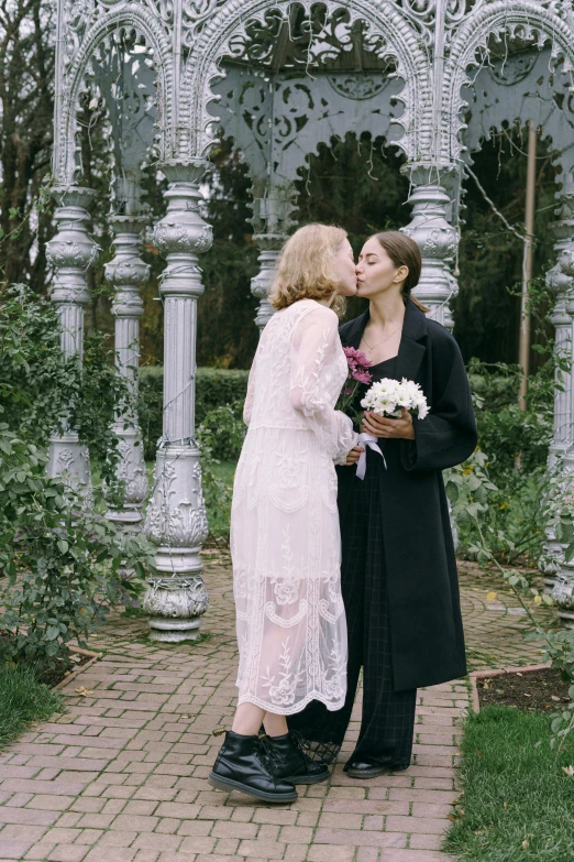 a couple of women standing next to each other, unsplash, romanticism, archways made of lush greenery, lesbian kiss, orthodox, official screenshot