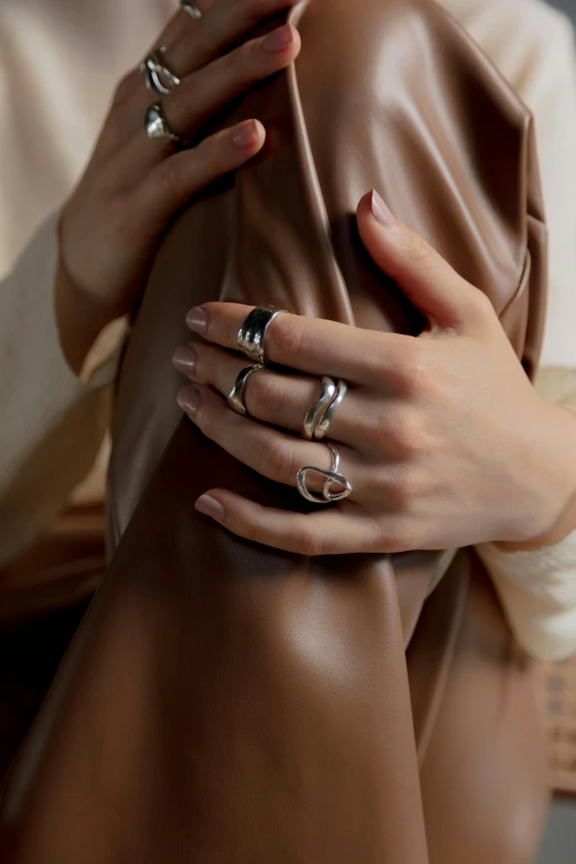 a close up of a person wearing rings on their hands, inspired by L. A. Ring, baroque, highly polished, vtm, background image, square