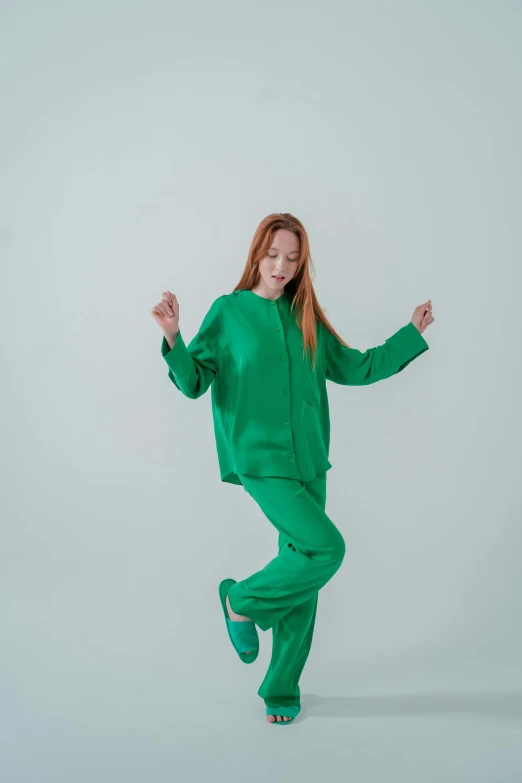 a woman in a green outfit is dancing, trending on unsplash, a portrait of issey miyake, wearing pajamas, full body hero, young teen