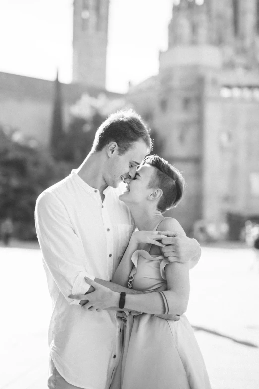 a man and woman standing next to each other in front of a building, a black and white photo, by Giuseppe Avanzi, castle in the background, summer feeling, in a square, headshot profile picture