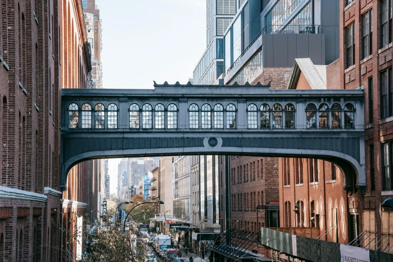 a city street filled with lots of tall buildings, by Nina Hamnett, unsplash contest winner, art nouveau, high bridges, mta subway entrance, steel archways, three quarter view