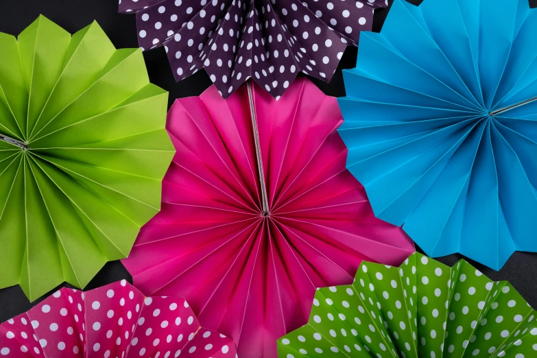 a bunch of paper flowers sitting on top of a table, by Rachel Reckitt, unsplash, kinetic art, polka dot, vibrant fan art, coated pleats, cosmopolitan