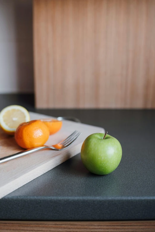 a knife, oranges, and an apple on a cutting board, modern minimalist f 2 0, indoor picture, subtle detailing, in a kitchen